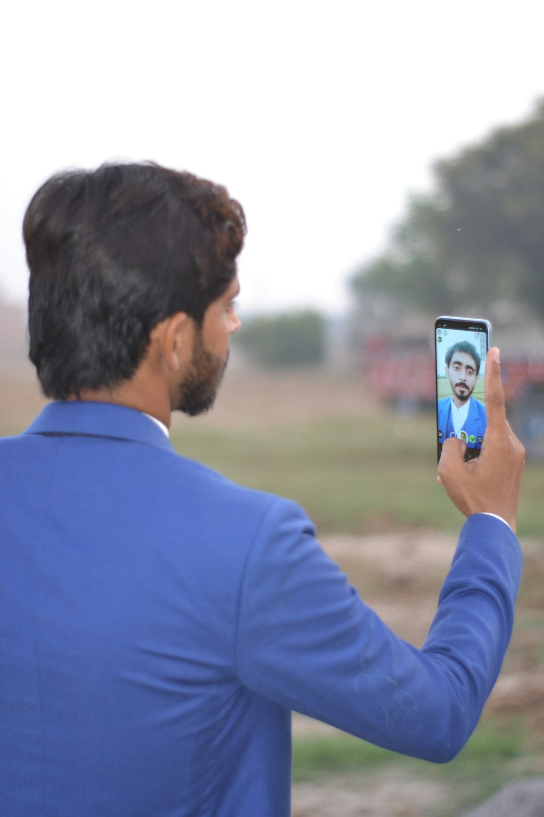 project-02-a a-man-in-a-blue-suit-taking-a-picture-of-himself-shbymqugcbm