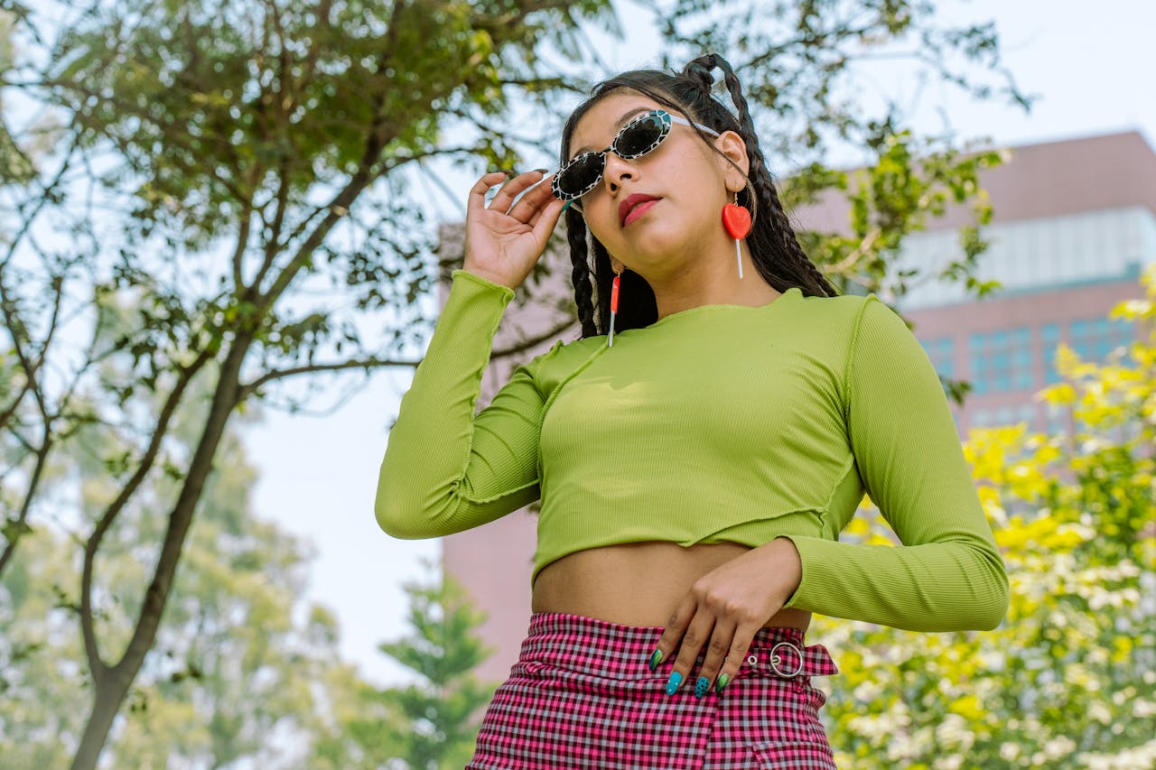 services-01 Fashionable woman in shades poses confidently in vibrant outfit outdoors in Mexico City.