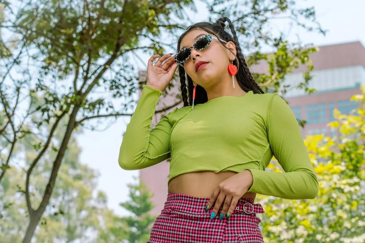 Fashionable woman in shades poses confidently in vibrant outfit outdoors in Mexico City.